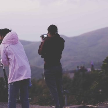 people-photographing-mountains-sunset